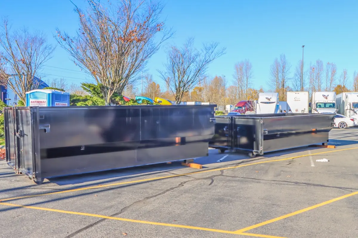 Professional dumpster rental service with roll-off container on residential driveway in Doral